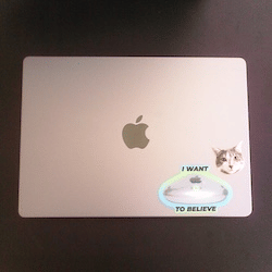 Photo of the lid of a 14 in MacBook Pro with two stickers