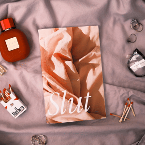 'Slut' zine cover, a square closeup image of pink bed sheets with the text Slut written in a big, white, italic, serif font.