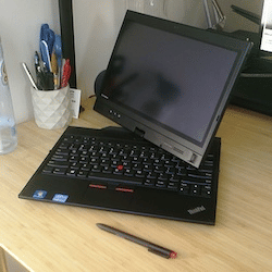 A black Lenovo ThinkPad with its screen slightly swiveled
